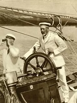 Strait Collection: King George V at the wheel of of his yacht, Britannia, during Cowes Regatta week, 1924, (1935)