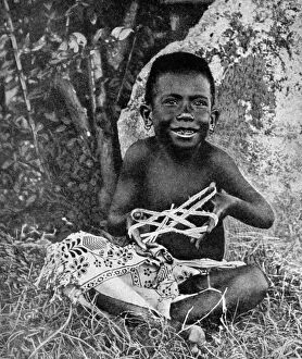 String Gallery: Kiwai child, living at the entrance to the Fly River, New Guinea, 1922. Artist: WN Beaver