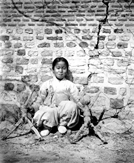 Korean girl with dolls, 1900