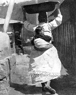 Peoples Of The World In Pictures Gallery: A Korean woman carrying a baby on her back, 1936.Artist: Wide World Photos