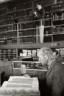 A labourer reads a book in a library, Germany, 1936