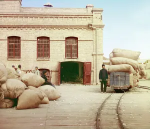 Goods Yard Prints: Labourers loading sacks onto railway at factory warehouse