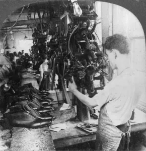Leather Prints: Lasting machine shaping shoes in shoe factory
