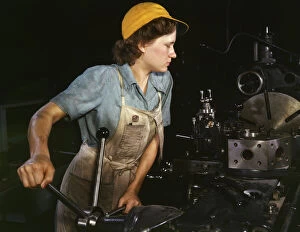 Lathe operator machining parts...Consolidated Aircraft Corporation plant, Fort Worth, TX, 1942. Creator: Howard Hollem