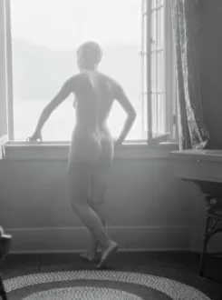 Lee, Margaret, Miss, standing at a window, 1927 Creator: Arnold Genthe