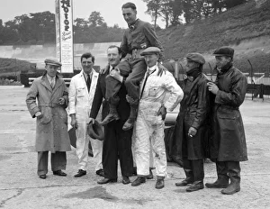 Cushman Prints: Leon Cushman being carried aloft after making a successful speed record attempt