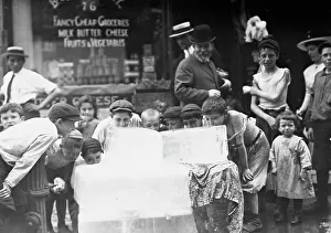 Licking Prints: Licking blocks of ice on hot day, between c1910 and c1915. Creator: Bain News Service
