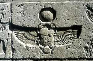 Limestone relief of a scarab beetle and vulture wings under a disk of the sun, Edfu, Egypt Limestone relief of a scarab beetle and vulture wings under a disk of the sun, Edfu, Egypt