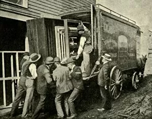 Teamwork Gallery: Loading The Camera On A Van For Removal, 1901. Creator: Unknown