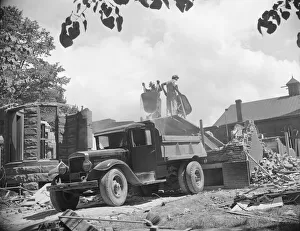 Loading debris from wrecked buildings along Independence Avenue, Washington, D. C, 1942. Creator: Gordon Parks