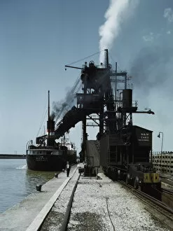 Jacob Ovcharov Gallery: Loading a lake freighter with coal at the Pennsylvania R.R. coal docks...Sandusky, Ohio, 1943