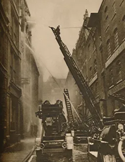 Conflagration Prints: How The London Fire Brigade Comes To Grips With Its Enemy, c1935. Creator: Unknown