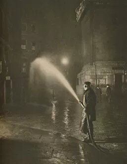 Cobblestone Gallery: Londons Nightly Cleaning: Scene at the Base of the Monument, c1935. Creator: Unknown