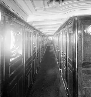Porthole Collection: Long wood panelled corridor on steam yacht Venetia, 1920. Creator: Kirk & Sons of Cowes