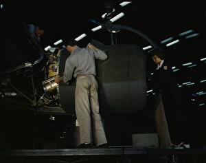 Consolidated Aircraft Corporation Gallery: Lowering an engine in place in assembling a C-87...Consolidated Aircraft