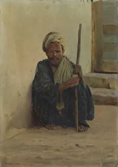 Luxor, Arab holding a stick sitting in a street, 1892. Creator: Henry Brokman