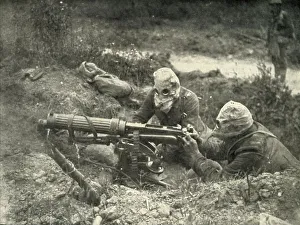W Stanley Macbean Knight Prints: Machine Gunners in Action Wearing their Gas Helmets, (1919). Creator: Unknown