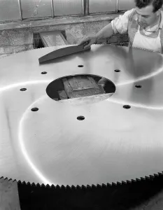 Steelworker Prints: A machinist quality checking a six foot circular saw blade