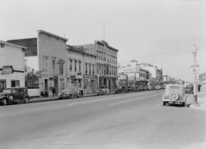 Stores Prints: Up the main street of a valley town, Gilroy, California, 1938. Creator: Dorothea Lange