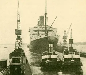 Graving Dock Prints: The Majestic Entering Dry Dock Hauled by Tugs, c1930. Creator: Unknown