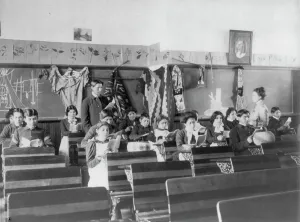 Male and female students reading in class, Carlisle Indian School, Carlisle, Pennsylvania, 1901. Creator: Frances Benjamin Johnston