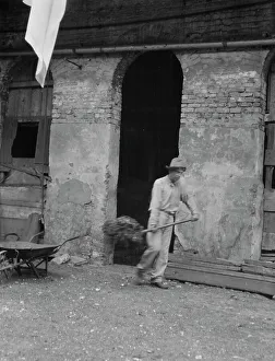 Cleaning Prints: Man cleaning out a small building