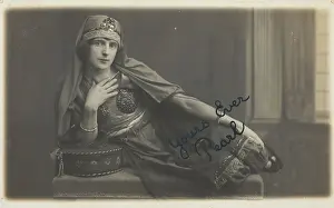 Cross Dressing Prints: A man in drag, poses wearing delicate attire; curled up on a piece of furniture