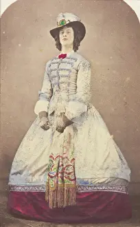 Crinoline Prints: A man in drag wearing an elaborate dress and feathered hat