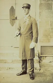 Service Prints: A man dressed wearing a long coat and a hat bearing the word 'Cook'