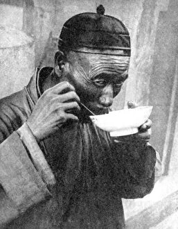 Peoples Of The World In Pictures Gallery: A man eating, Mukden (Shenyang), China, 1936.Artist: Wide World Photos