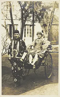 Porter Prints: A man in ornate drag sits in a dog-cart and is pulled along the road by