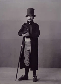 Tophat Collection: A man poses in folk costume with a long coat and a top hat, 1880-1907. Creator: Helene Edlund