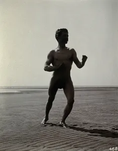 Boxing Prints: A man posing naked in a boxing stance with his fists raised