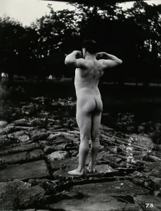 Flexing Prints: A man posing naked, with his back to the camera