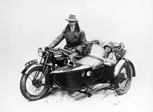 Sidecar Prints: Man riding an AJS motorbike with a woman in the sidecar, 1939