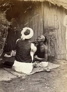 Sitting On Ground Prints: Man being shaved in one of the hospital camps