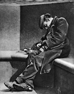 A man sleeping on Blackfriars Bridge, London, 1926-1927. Artist: Walter Benington