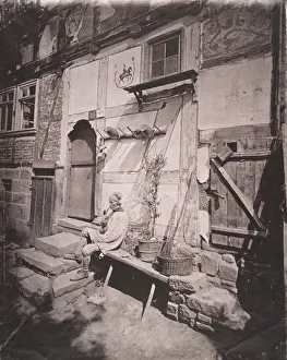 Half Timbered Prints: [Man Smoking Pipe Outside His Home on Village Street], 1880s. Creator: Unknown
