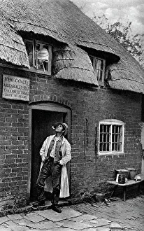 Images Dated 4th December 2009: A man smoking a pipe outside a shop, Worcestershire, c1922.Artist: AW Cutler