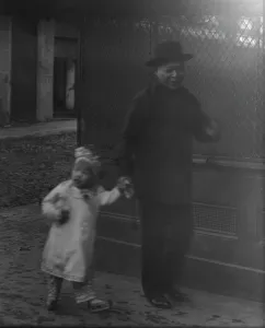 Chinese American Prints: Man and a young child walking down a street
