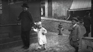 Chinese American Prints: Man and a young child walking down a street