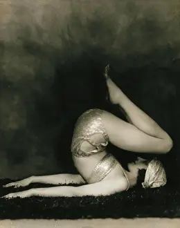 Bending Prints: Marguerite Agniel posing with her back arched and feet in the air