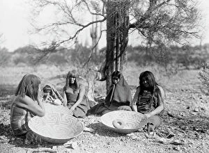 Basket Collection: Maricopa group, Arizona. Four women and a child seated on ground with three large basket
