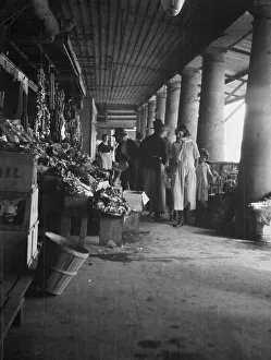 Stall Prints: Market scene, New Orleans, between 1920 and 1926. Creator: Arnold Genthe