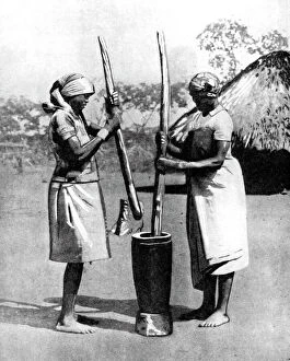 Images Dated 13th November 2007: Two Mashona tribeswomen pounding maize and millet, Zimbabwe, Africa, 1936.Artist: Wide World Photos