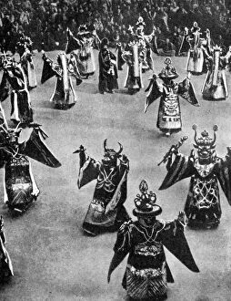 Masked dancers, Tibet, 1936.Artist: Ewing Galloway