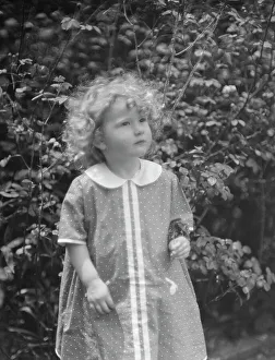 McCormick, Medill, child of, standing outdoors, 1923 May 21. Creator: Arnold Genthe