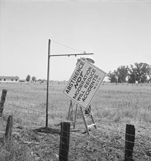 Prevention Gallery: Member of the committee...erects sign on the highway, U.S. 99, near Hanford, CA, 1939