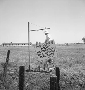 Prevention Gallery: Member of the committee...erects sign on U.S. 99 highway, near Hanford, California, 1939