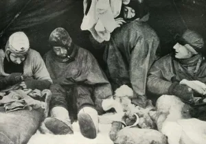 Team Prints: Members of the Polar Party Getting Into Their Sleeping-Bags, c1911, (1913). Artist